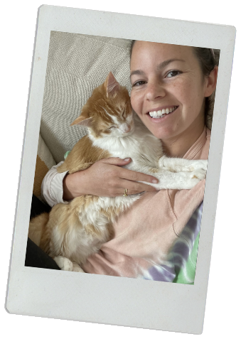 Colette snuggling her fluffy orange cat