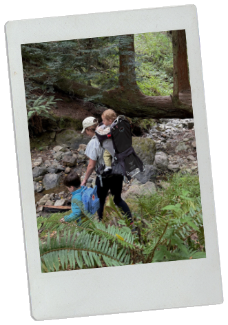 Colette's family hiking by a creek in the redwoods